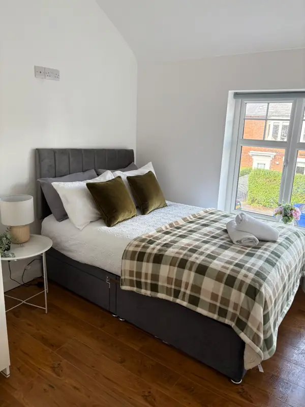 Bedroom made up with fresh linen and rolled towels, Belfast