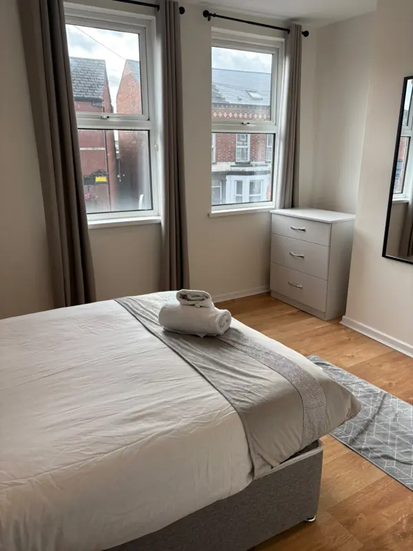 Bedroom with fresh linen and folded towels, Belfast