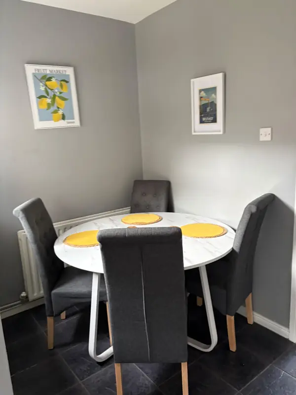Dining corner with table wiped and set, Belfast