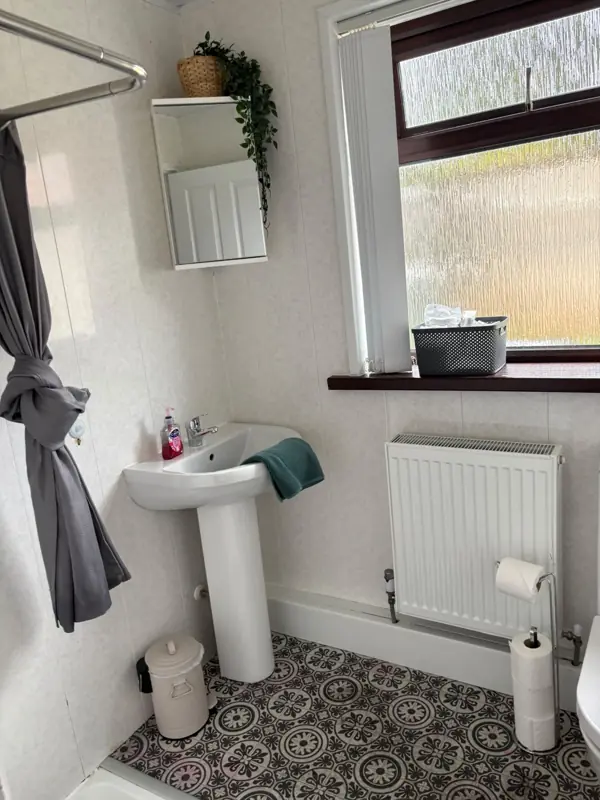 Bathroom basin cleaned and fresh towel left, Belfast